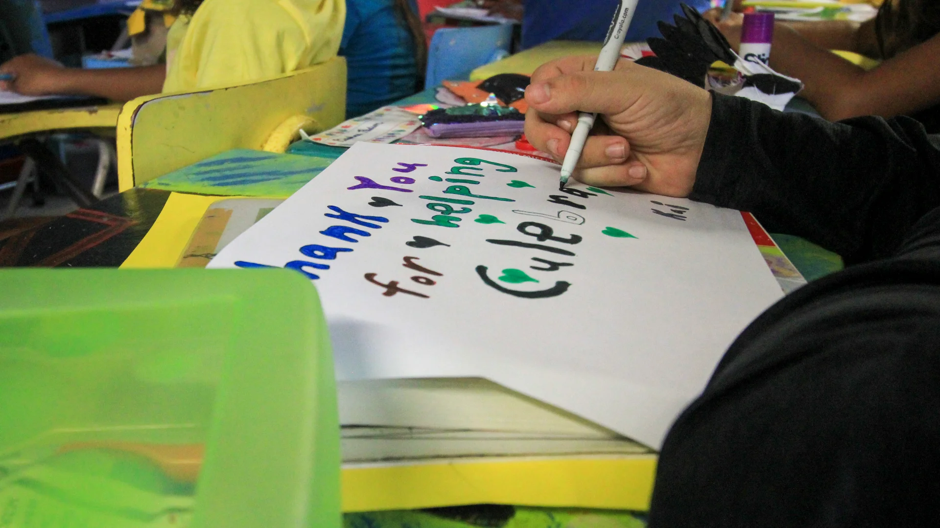 Volunteers helping students